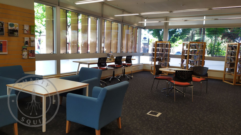 inside Bordertown Library looking tables and chairs along the window and in the middle of the room